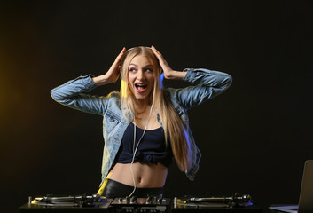 Female DJ playing music in club