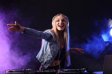 Female DJ playing music in club
