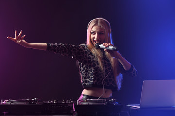 Female DJ playing music in club