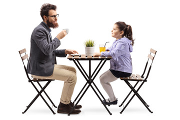 Father and daughter at a cafeteria drinking coffee and orange juice