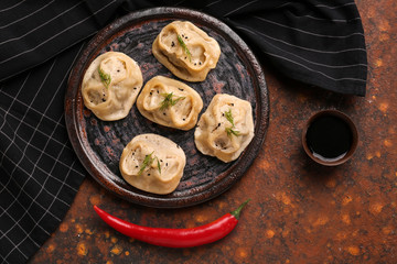 Plate with tasty dumplings on table
