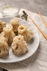 Plate with tasty dumplings on table