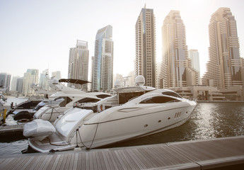 Dubai Marina. Modern yachts, water pier, skyscrapers. United Arab Emirates