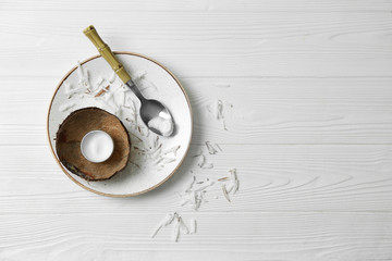 Cosmetics with natural ingredients on white wooden background