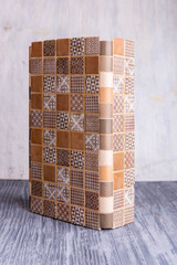 Sample of an angular multi-colored tile of beige and brown color