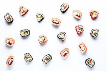 Tasty sushi rolls on white background