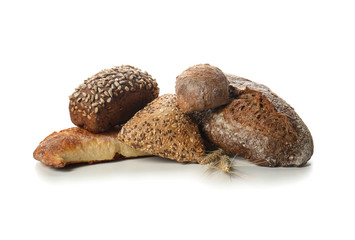 Loaves of fresh bread on white background