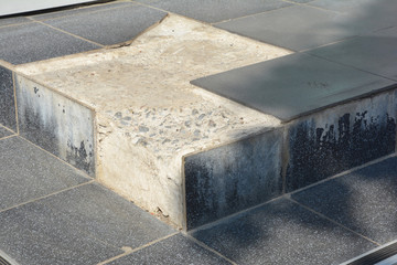 Broken gray tiles on house entance door steps
