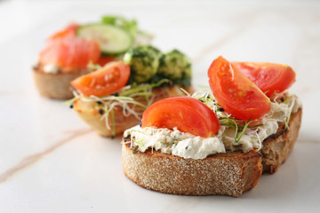 Fresh tasty bruschettas on light background