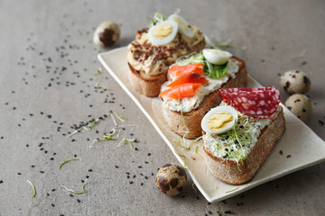 Plate with fresh tasty bruschettas on table