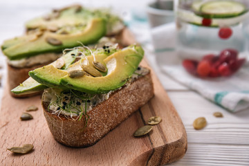 Board with fresh tasty bruschettas on table, closeup