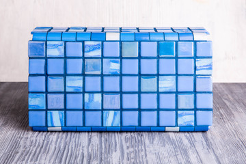 A square tile of blue color with marble inserts