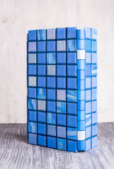 A sky blue angular tile with blue inserts
