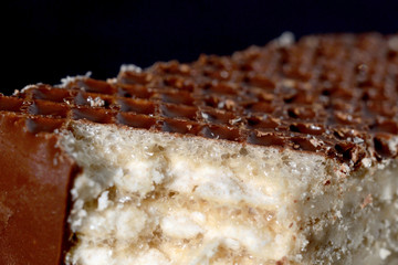 Slice of iced waffle cake closeup. Shallow depth of field