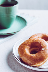 Front view of a group of sweet donuts with coffee cup
