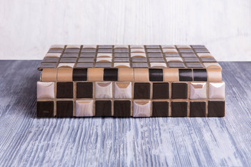 An exhibition sample of an angular tile with black inserts and marble inserts