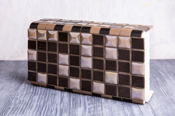 An angular tile for bathrooms and kitchen with marble inserts