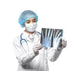Female doctor studying X-ray image on white background