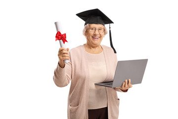 Smiling elderly woman with laptop, diploma and a graduation hat