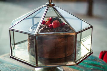 Chocolate strawberry cake in display case