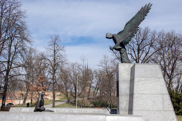 Monument of Katyn massacre in sunlight. The Lower Silesian Family Of Katyn black sculpture