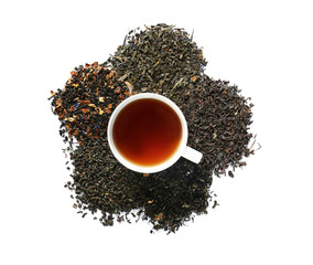 Cup of hot tea and dry leaves on white background