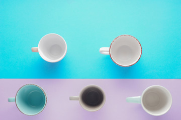 Empty cups on color background