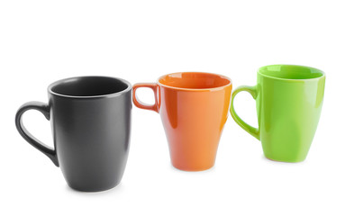 Colorful empty cups on white background