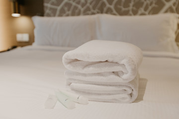 Fototapeta na wymiar white towel decoration on bed in bed room interior