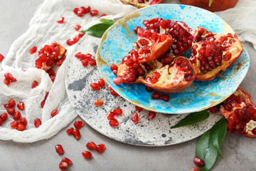 Obraz na płótnie Canvas Plate with pieces of tasty pomegranate on table