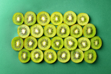 Tasty sliced kiwi on color background