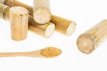 wooden spoon with brown sugar, on white background
