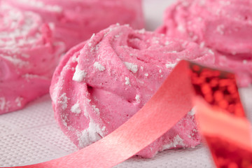 Homemade pink marshmallow on a white kitchen napkin close-up.