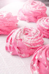 Homemade pink marshmallow on a white kitchen napkin close-up.