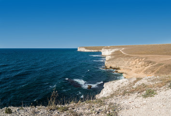 Fototapeta na wymiar Steep cliff and azure water