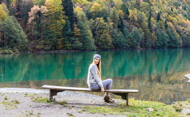 Fototapeta na wymiar Beautiful girl on a background of lake, mountain lake