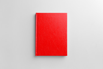 Book with blank cover on light background