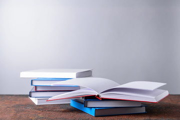 Many books on table against grey background