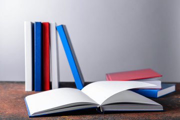 Many books on table against grey background