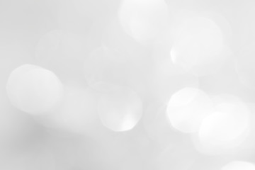 A brilliant white background with circles and ovals. Template for a holiday card with bright and sparkling lights.