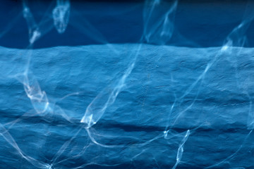 Blue abstract surface with reflections useful as background.