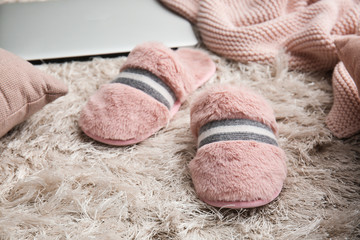 Female slippers on fluffy carpet