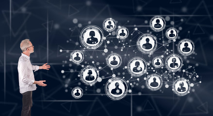A social network concept explained by a businessman on a wall screen