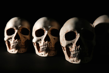 Human skulls on black background