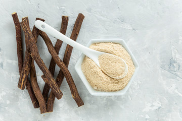 Powder and licorice root on the table - Glycyrrhiza glabra