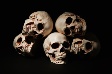 Human skulls on black background