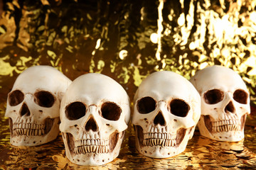 Human skulls on golden background