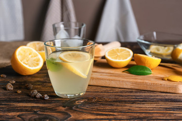 Glass of fresh lemonade on table
