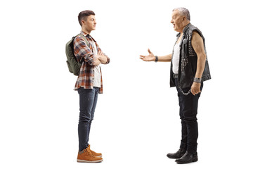 Elderly male punker talking to a young teenage male student