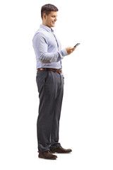 Young man in formal clotes holding a mobile phone and looking at it
